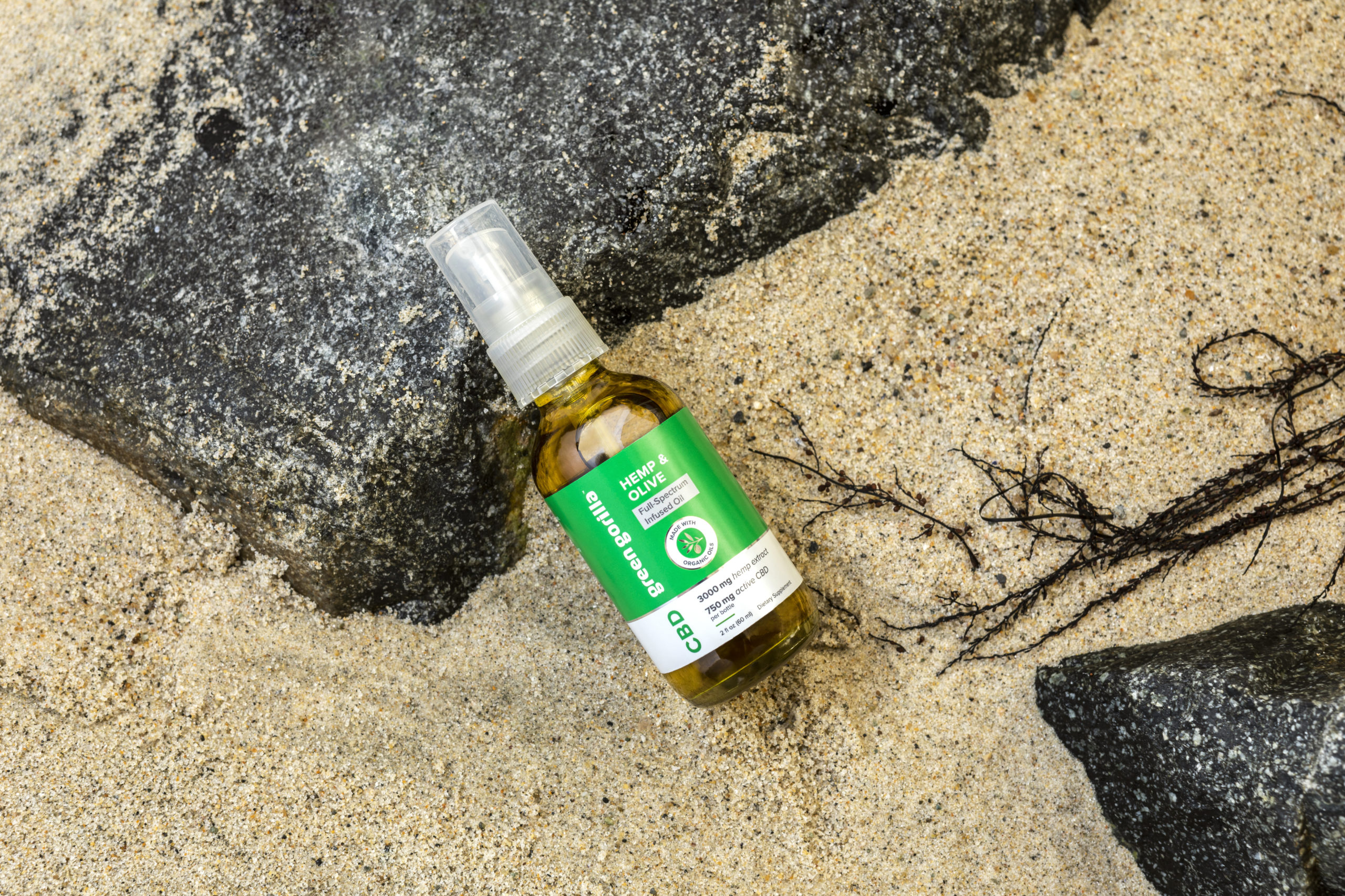 Full Spectrum CBD bottle laying on the beach