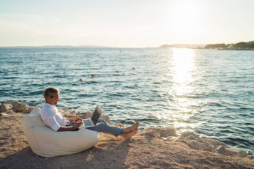 man using a laptop oceanside
