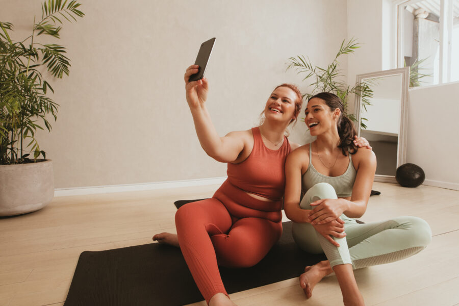 two friends on a yoga mat