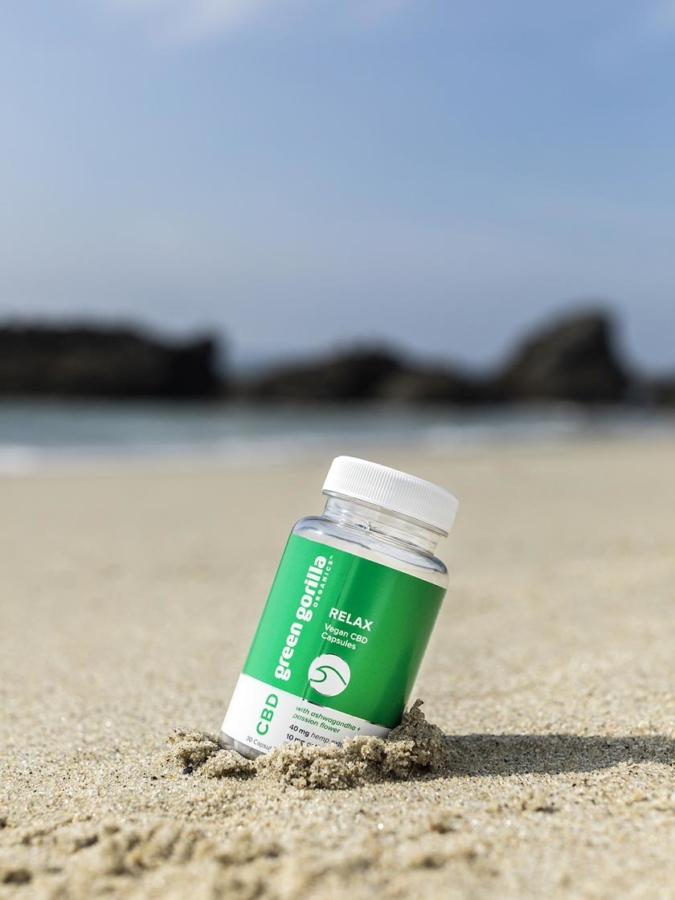 A bottle Green Gorilla™ Relax CBD capsules at the beach