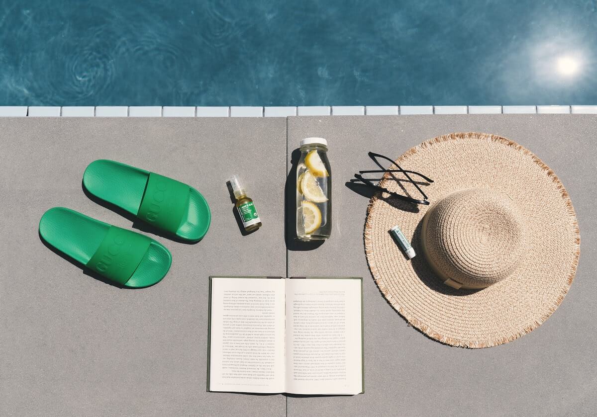 Green Gorilla Pure CBD Lip Balm along side a pool on a hot summer day.