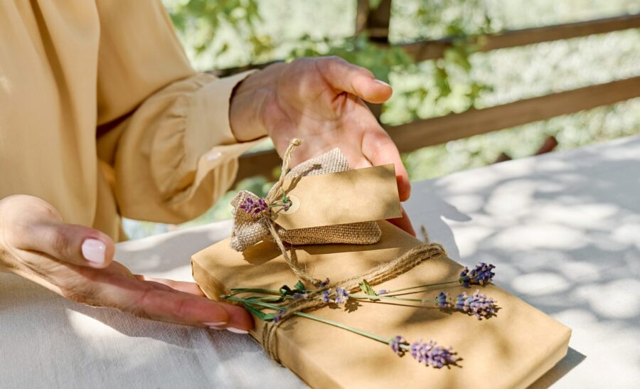 Handmade eco-friendly gift wrapped in kraft paper and lavender on linen table — calm, organic wellness