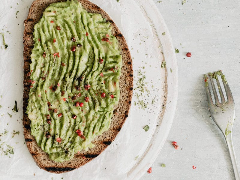 CBD avocado toast on a white plate