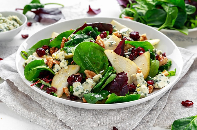 Winter pear salad with blue cheese, CBD oil dressing, and cranberries