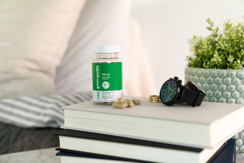CBD Relax Capsules on a nightstand next to a watch