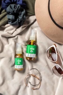 Two bottles of CBD oil for daily usage on a beach towel