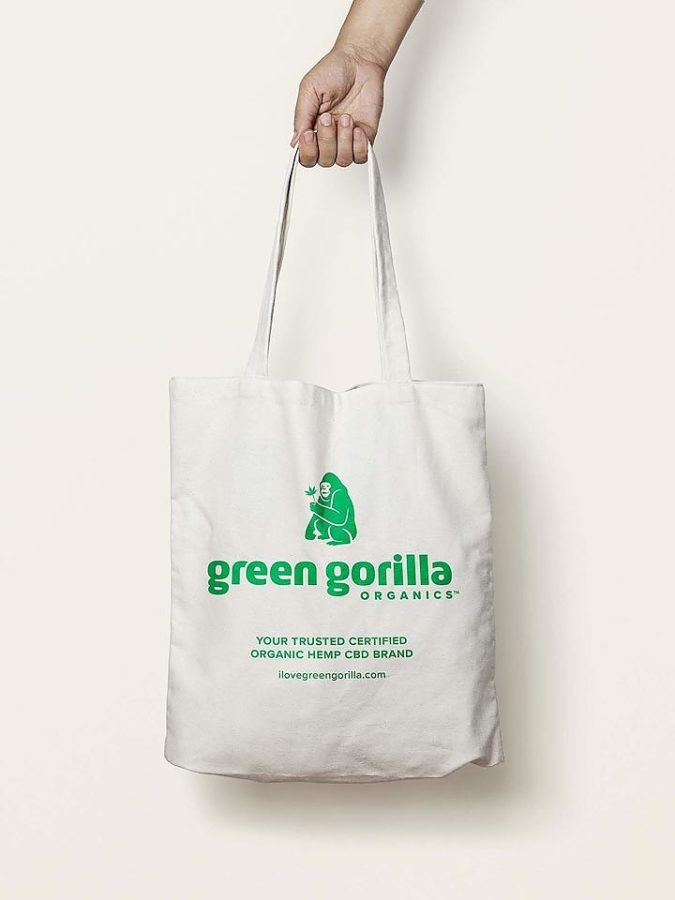Person holding a Green Gorilla™ canvas tote bag.