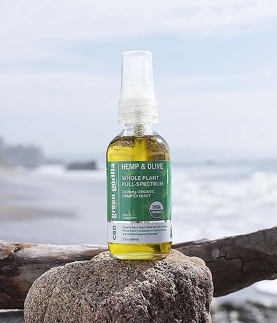 CBD oil dropper close up at the beach