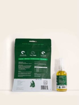 Back label view of a bag of Green Gorilla™ CBD dog nibs with a bottle of 2400mg full spectrum CBD oil for pets.