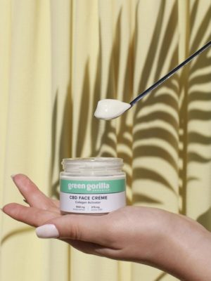 A spoonful of CBD balm over a jar