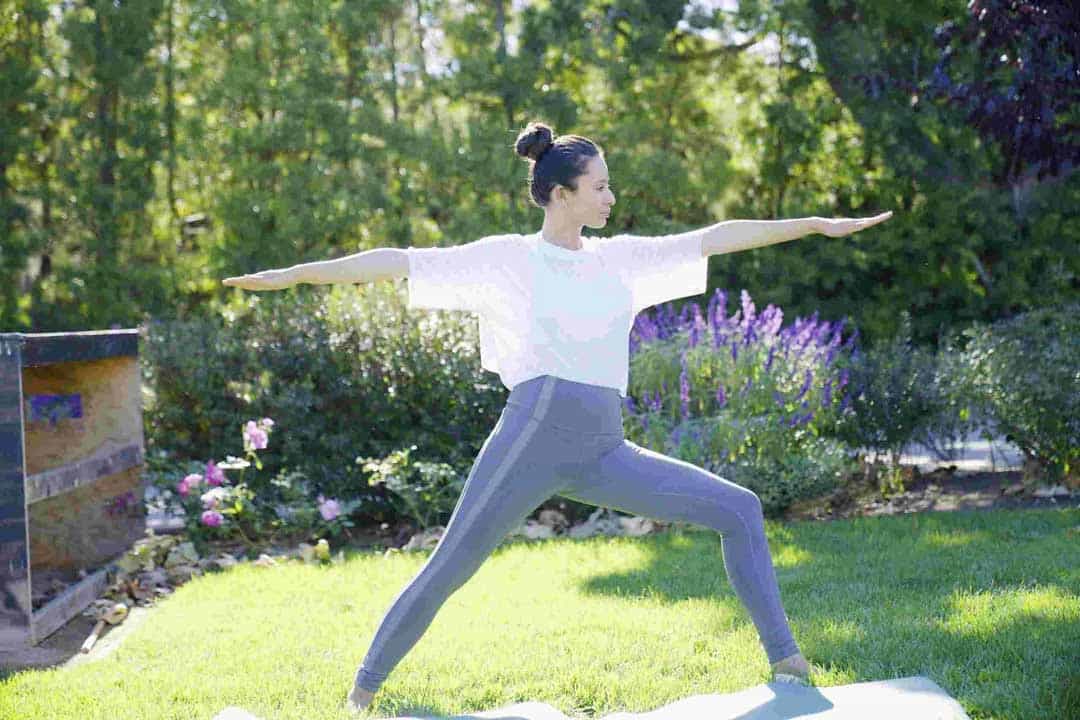 Woman doing yoga on the grass.