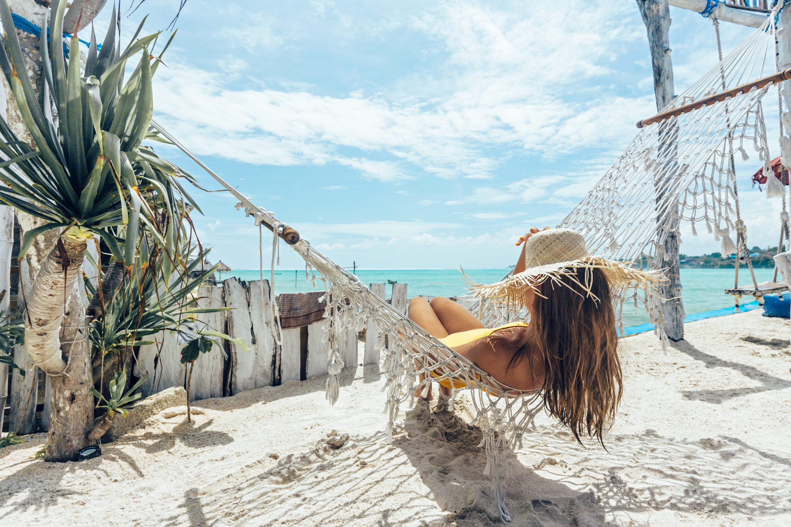 Woman laying back on hammock